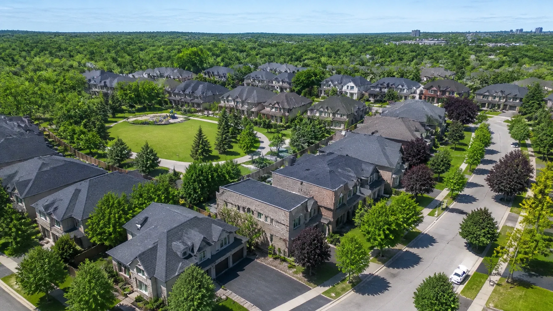 An aerial view of a premium, well-planned suburban neighbourhood in Richmond Hill, Ontario, showing lush greenery and modern homes.