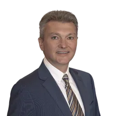 Professional portrait of a confident real estate professional, ready to assist clients.