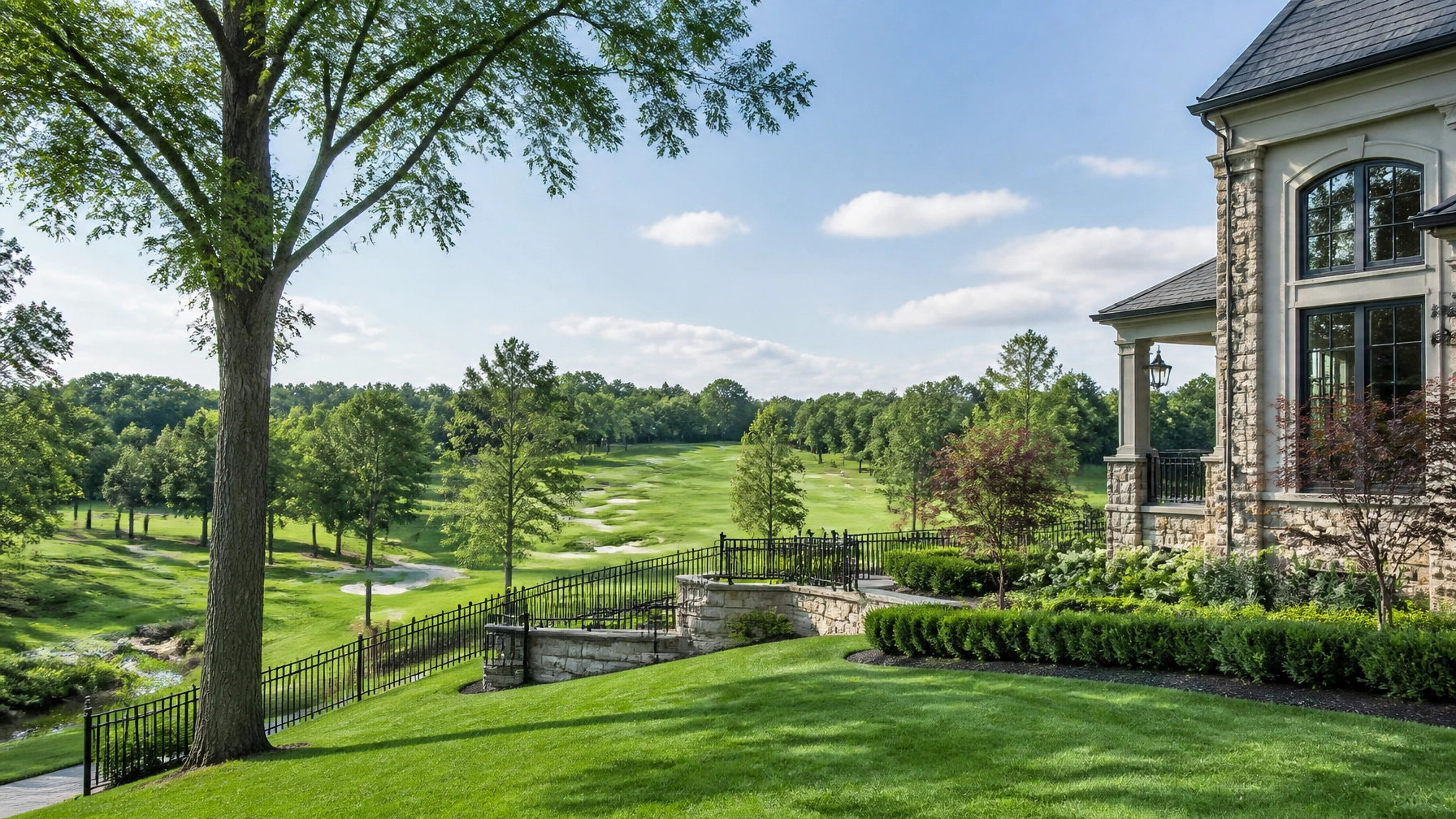A scenic view of a prestigious golf course community in Aurora, highlighting the lush green surroundings that define luxury living in the area.